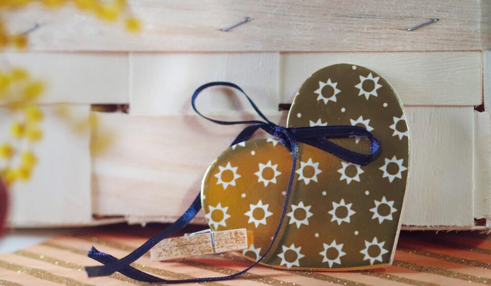 decorative heart, gift tag, rustic decor, wooden crate, handmade, romantic detail, craft design, valentine gift, sunflower pattern, love decoration, heart shape, ribbon bow, packaging design, cozy style, boho decor, romantic symbol, wedding decor, heart ornament, diy decor, artisan detail, small gift, celebration, floral pattern, love tag, wooden background